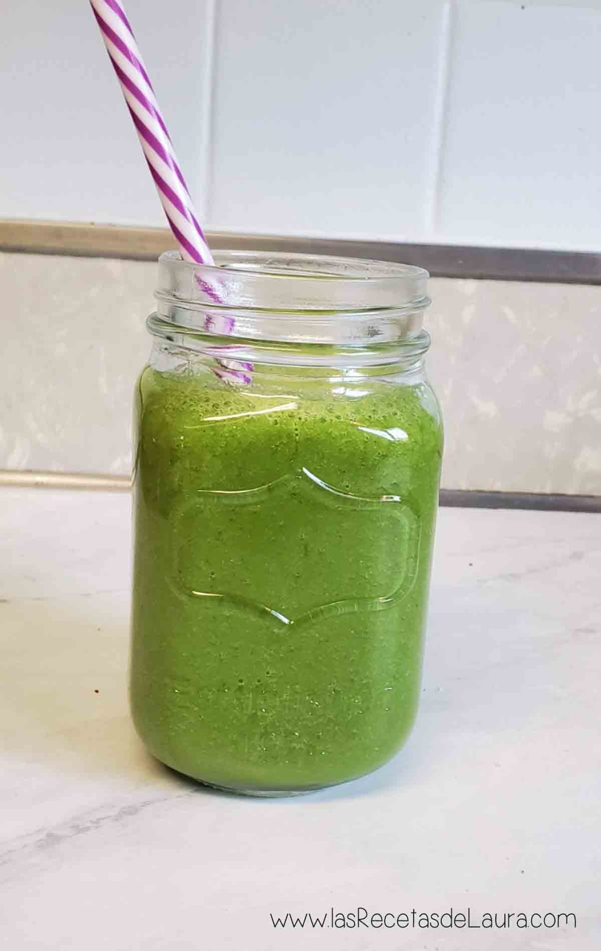 Vasito con popote de jugo con espinacas y limon